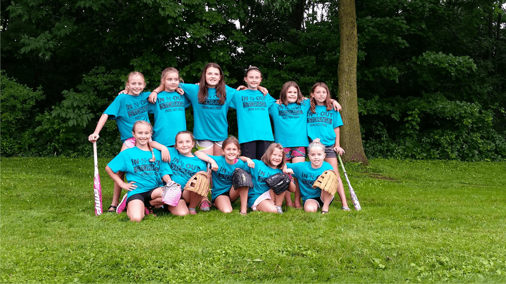 Image with girl little league softball team that is sponsored by In-N-Out Storage