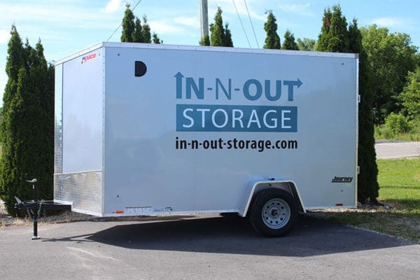 side view of enclosed trailer with logo on side promoting trailer rental service